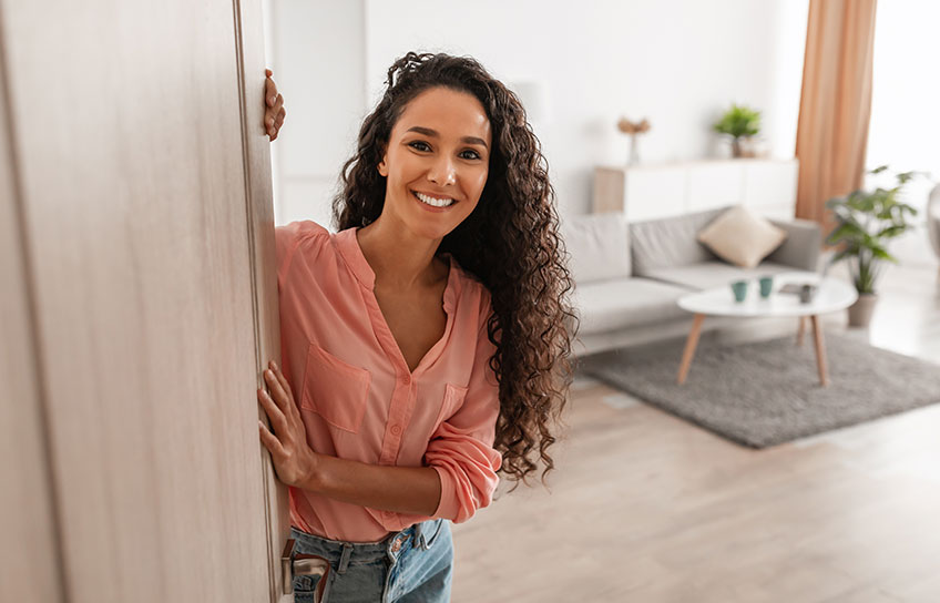 woman opening door to apartment